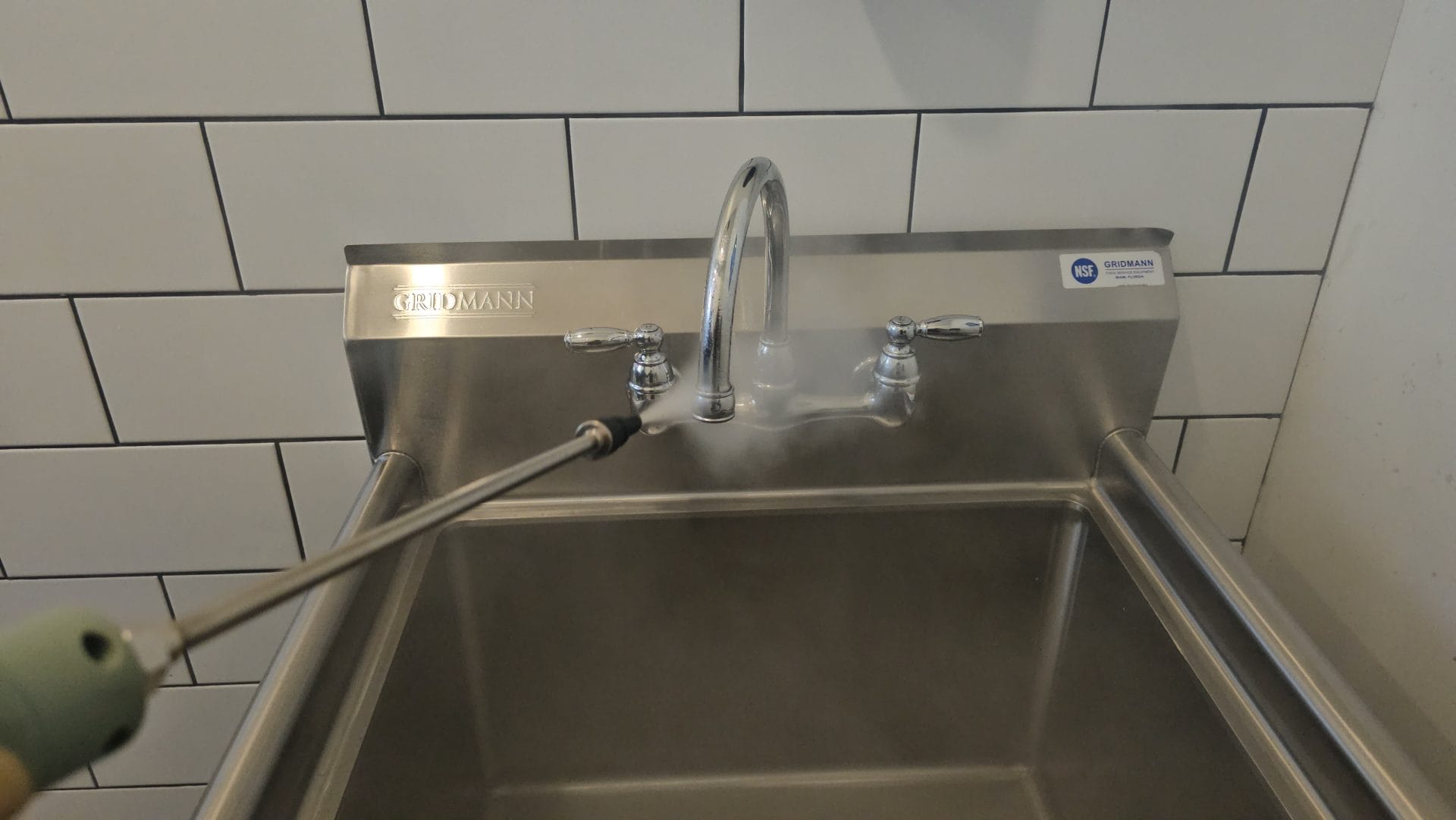 High pressure steam treatment sanitizing commercial stainless steel sink and faucet by Angst Cleaning Easton PA