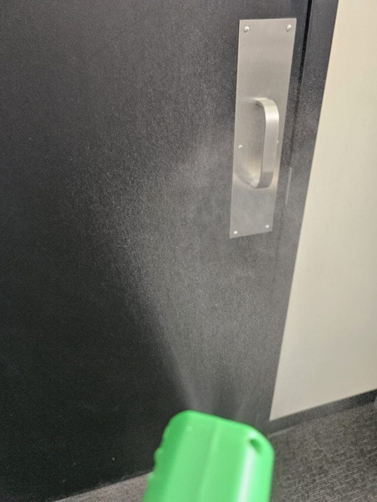 Electrostatic particle fogging disinfection applied to commercial door handle by Angst Cleaning Lehigh Valley PA